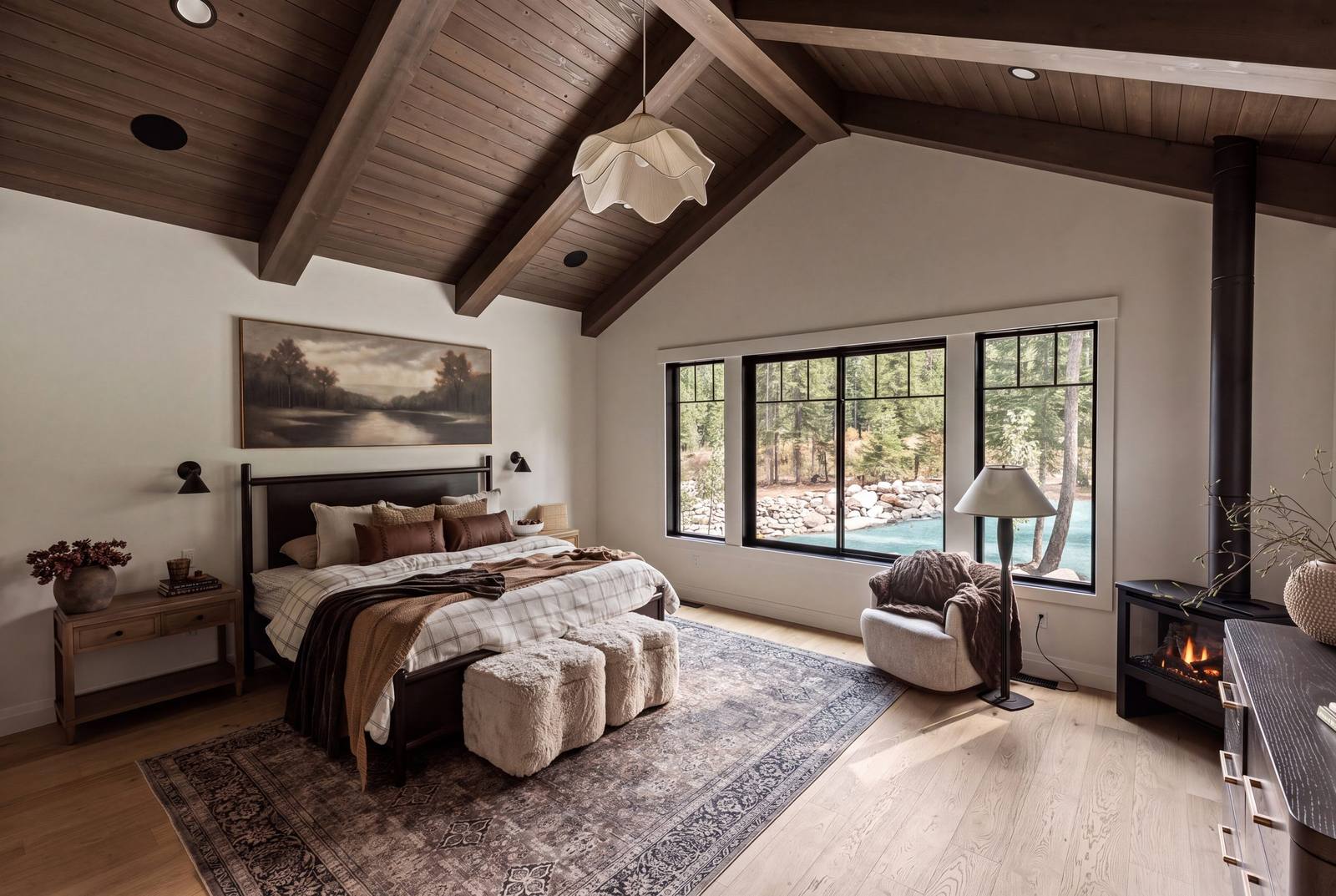 Primary suite with black clad windows looking out to the treeline